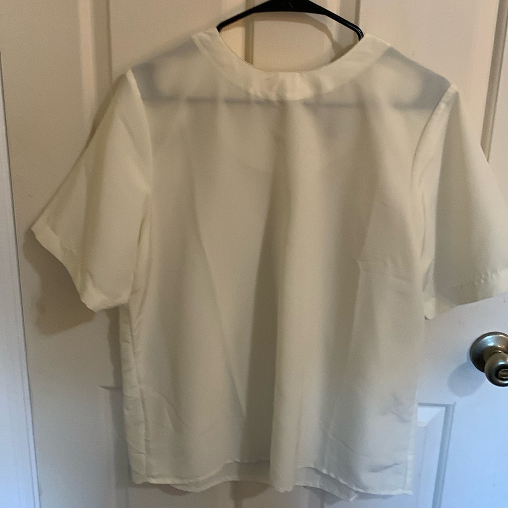 White, short sleeved blouse.